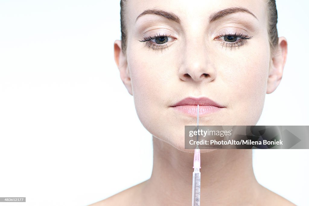 Woman holding up syringe