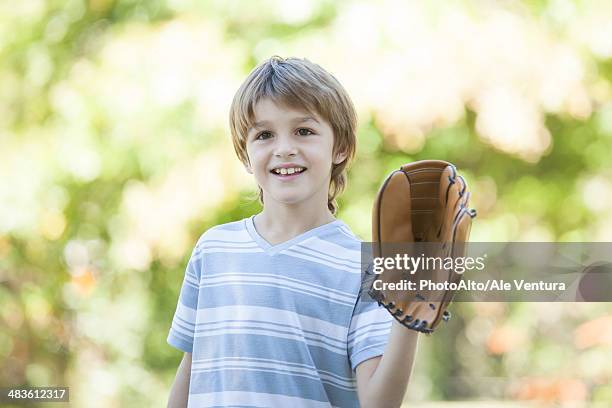 boy wearing baseball glove - baseball tee stock pictures, royalty-free photos & images