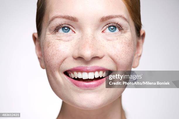 young woman smiling, looking away - anticipation face stock pictures, royalty-free photos & images