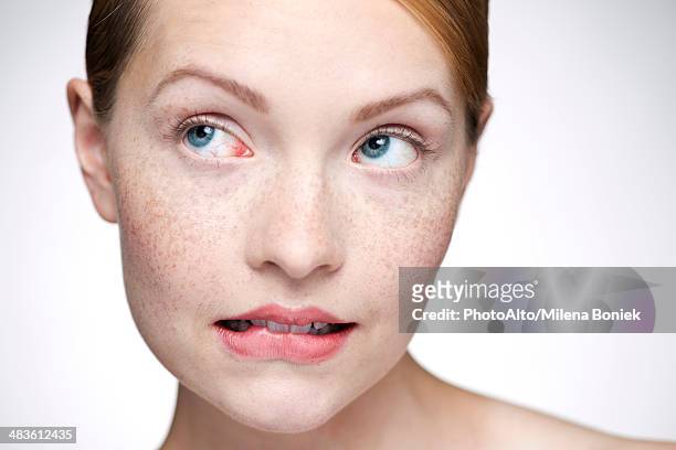 young woman biting lips - beauty treatment face stock-fotos und bilder