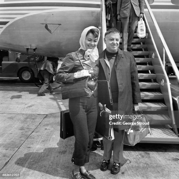 Actress Anne Heywood with her husband Raymond Stross, arriving at London Airport, 19th May 1968.