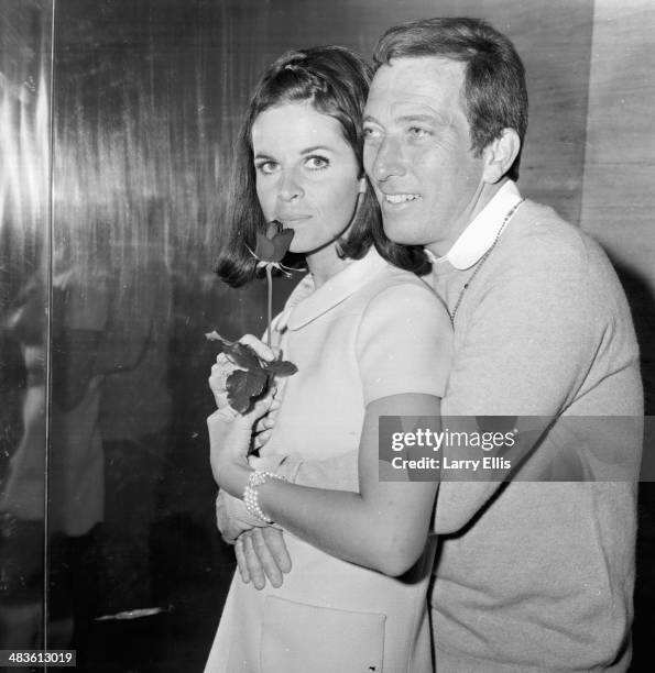 Singer Andy Williams holding a rose for his wife Claudine Longet at a press conference, 16th May 1968.