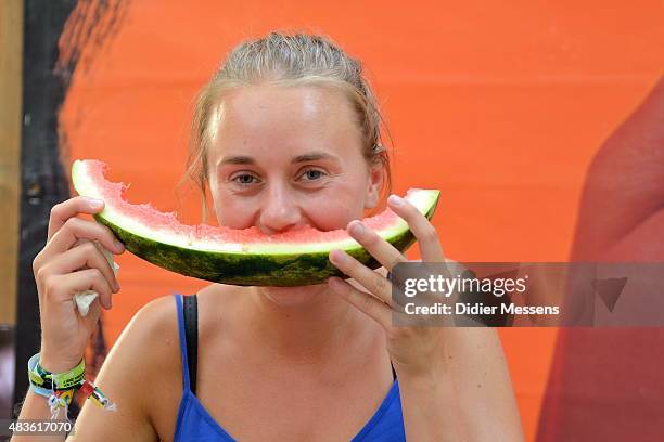 Fesitval goer eats a watermelon during the first day of the Sziget festival at Obudai Island on August 10, 2015 in Budapest, Hungary.