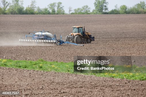 Large Tractor with Corn Planter in Field