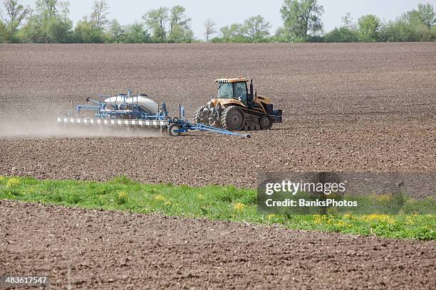large tractor with corn planter in field - sowing grass stock pictures, royalty-free photos & images