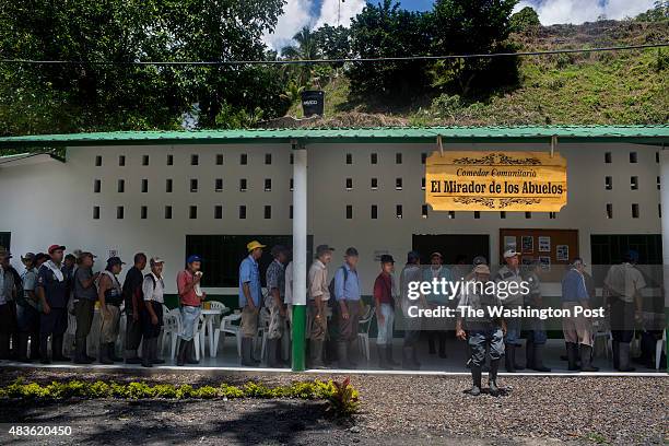 Line of people line up at the community eatery, El Mirador de los Abuelos, for lunch in the municipality of Muzo, department of Boyacá, Colombia, on...