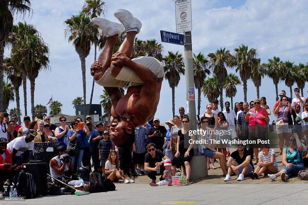 LOS ANGELES, CA - JULY 19: Street performers draw a large crowd