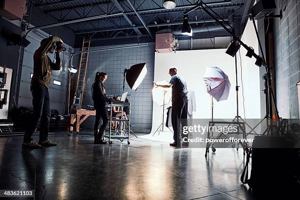 film crew working on set - film studio stock pictures, royalty-free photos & images