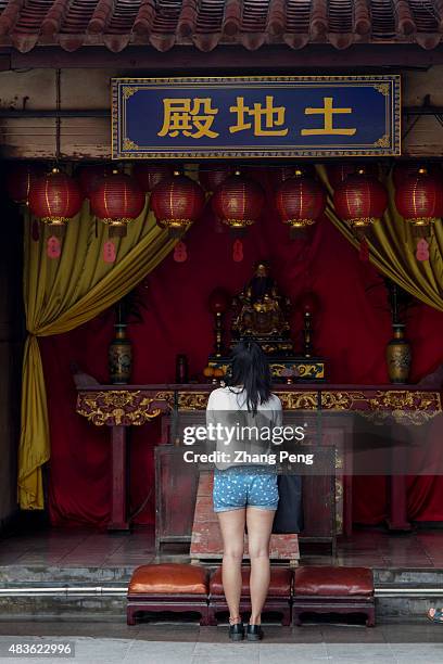 Young girl is praying to the God of Land. Xuanmiao Taoist temple, located in the east of Quanzhou city, first Taoist temple in Fujian built in 280289...