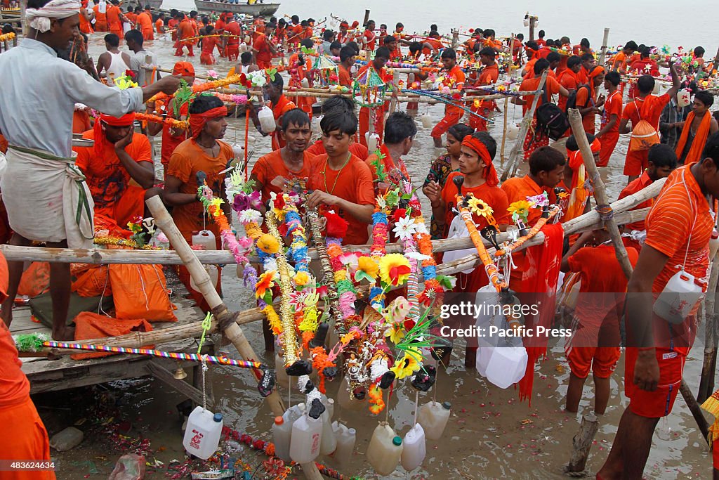 Kanwarias filling their pots with  water from the river...