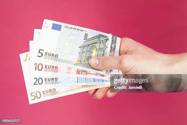 hand holding euro bank notes - euro in hand stock pictures, royalty-free photos & images