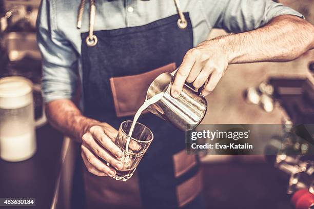 young barista is making a coffee - barista coffee milk stock pictures, royalty-free photos & images