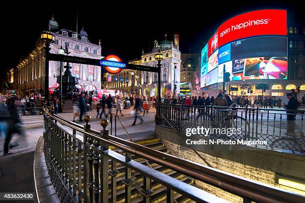 Long exposure of pedestrians and traffic outside Piccadilly Circus tube station in London, taken on October 21, 2014.