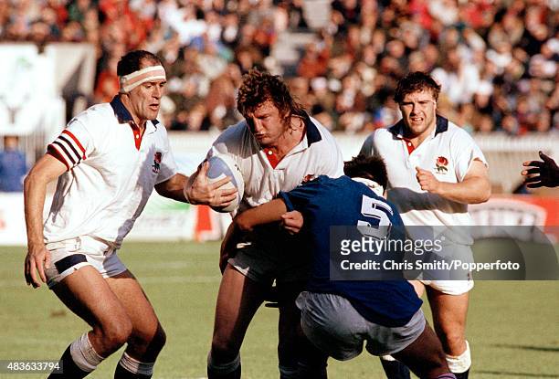 Mick Skinner of England is tackled by Olivier Roumat of France , watched by Jason Leonard and Paul Ackford, during the Rugby Union World Cup match...
