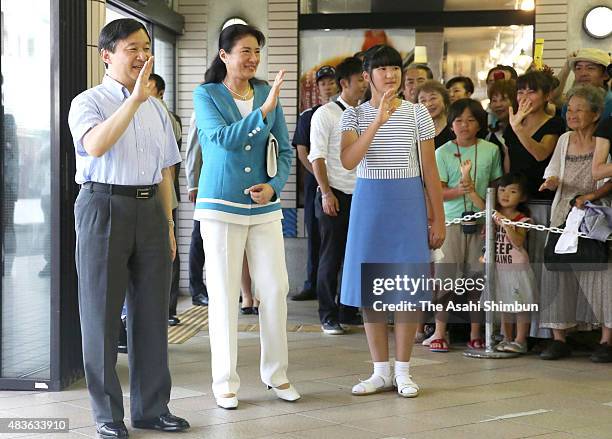 Crown Prince Naruhito, Crown Princess Masako and Princess Aiko wave to well-wishers upon arrival at Izukyu Shimoda Station on August 11, 2015 in...