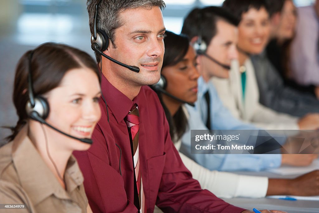 Businesspeople with headphones at meeting