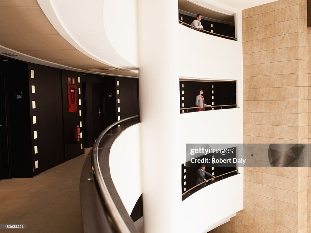 Business people standing at balcony in atrium