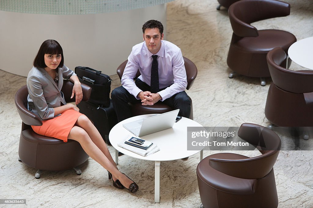 Business people in lobby looking up