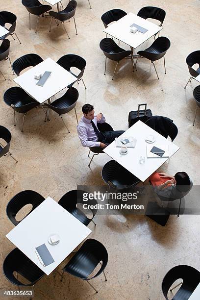 business people working in cafe - three quarter length stockfoto's en -beelden