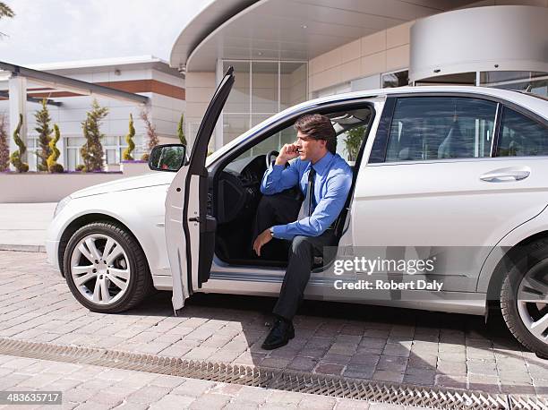 businessman sitting in car talking on cell phone - man talking to camera stock pictures, royalty-free photos & images