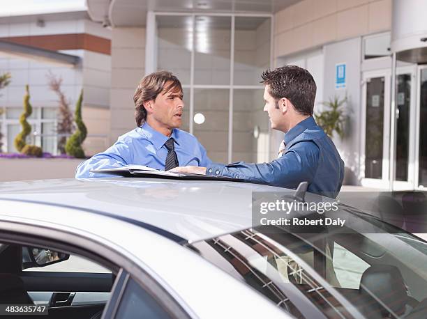 businessmen talking near car - man talking to camera stock pictures, royalty-free photos & images