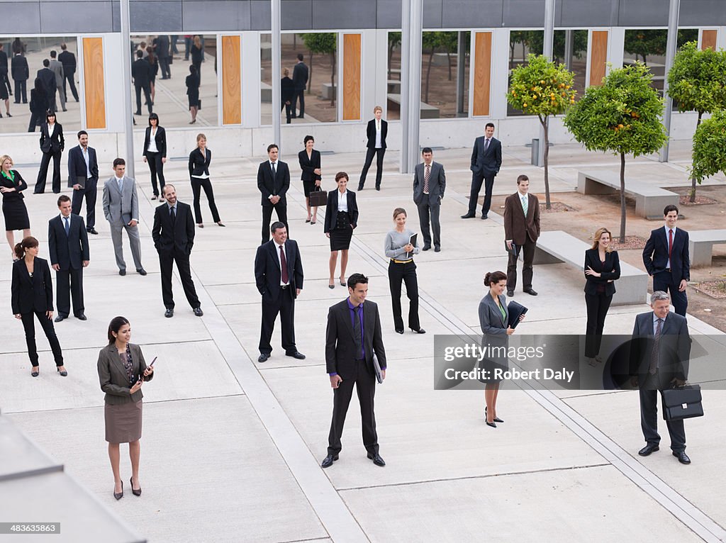 Businesspeople in modern office courtyard