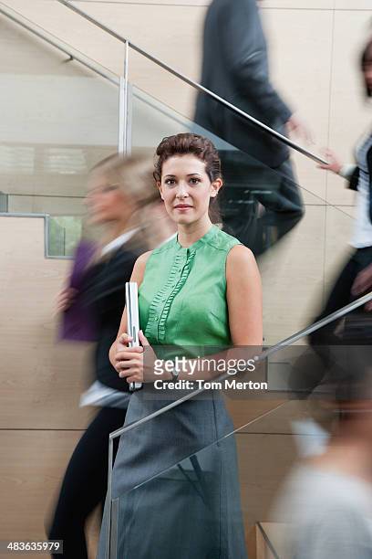 calm businesswoman in staircase - portrait of young woman standing against steps stock pictures, royalty-free photos & images
