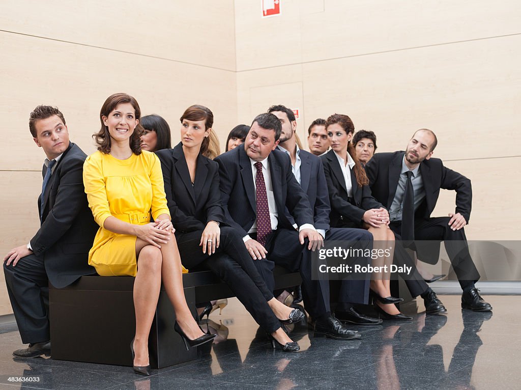 Businesspeople staring at unique co-worker