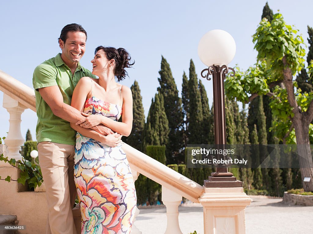 Couple hugging on outdoor staircase