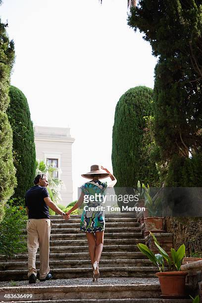 couple walking up outdoor staircase - elegance family stock pictures, royalty-free photos & images