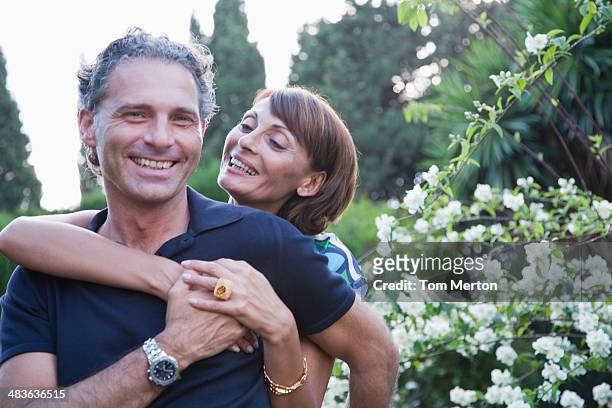 couple hugging outdoors - 50 59 years stock pictures, royalty-free photos & images
