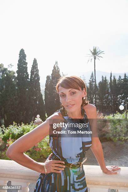 woman leaning on balcony railing - snob stock pictures, royalty-free photos & images