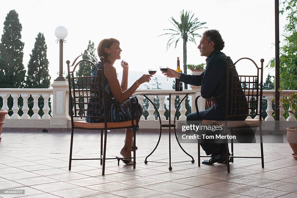 Couple having wine on balcony