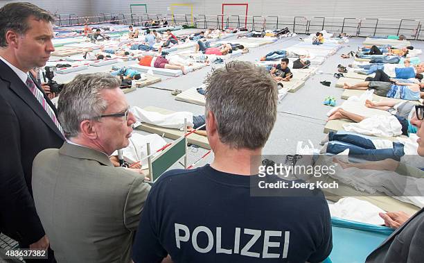 German Minister of the Interior Thomas de Maizere visits an initial registration center of the German federal police on August 11, 2015 in...