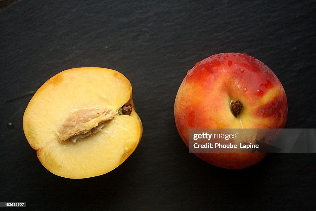 Fresh peach and halved peach