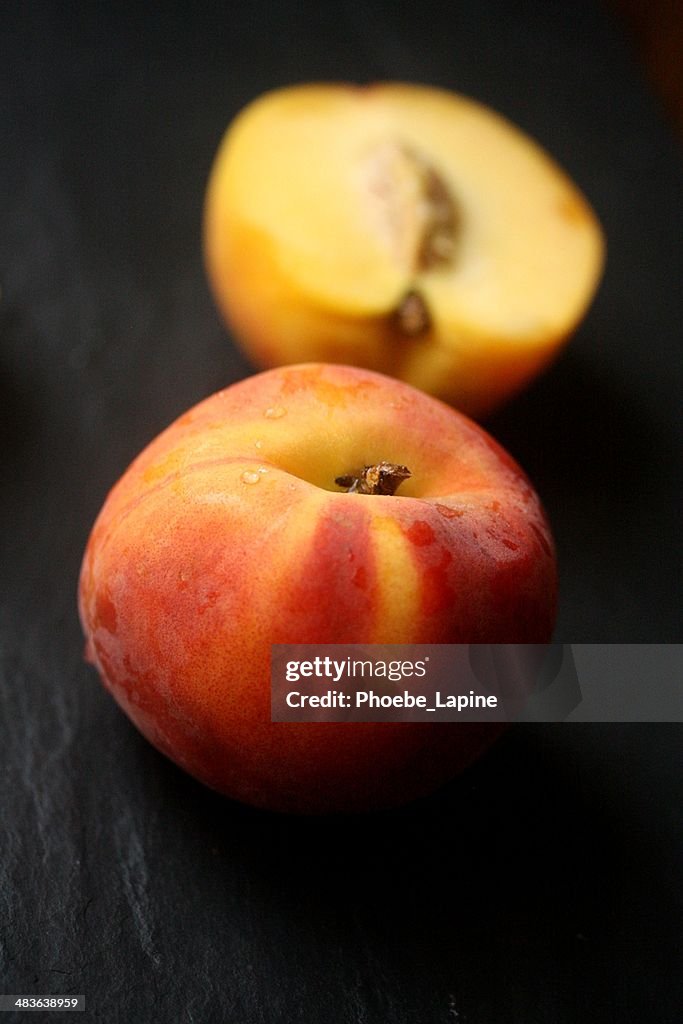 Fresh peach and halved peach