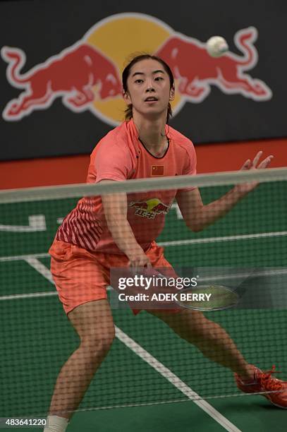 Wang Shixian of China hits a return as she plays against Iris Wang of the US during their women's singles qualifying match at the 2015 World...