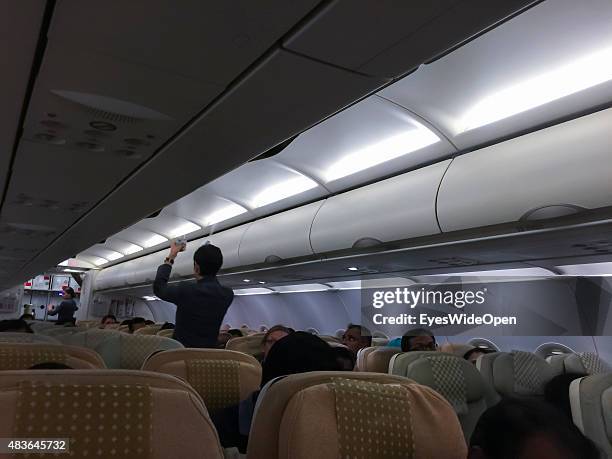 Stewardess with desinfection spray on board of an Emirates Airline jet on December 21, 2014 in Varkala, Kerala, India