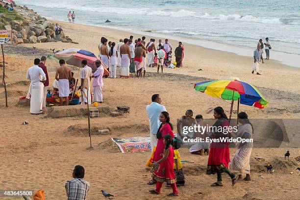 Locals, fishermen, gurus and tourists spend their holidays at the beach on December 21, 2014 in Varkala, Kerala, India