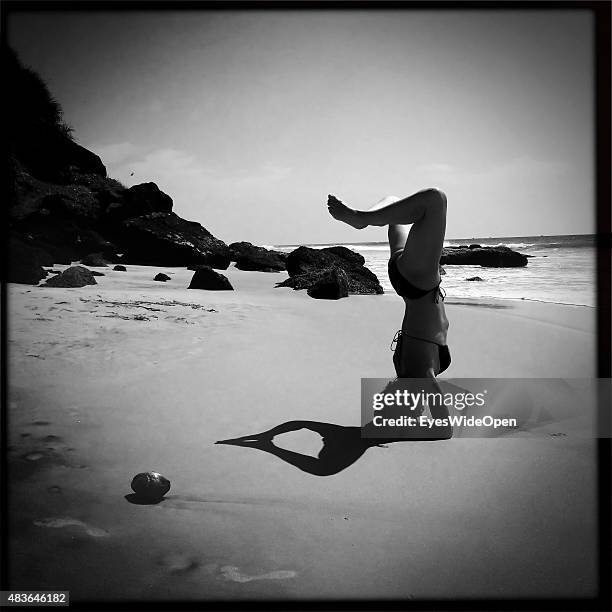 Woman doing Yoga on the beach on December 21, 2014 in Varkala, Kerala, India