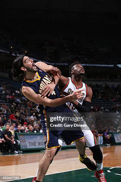 Luis Scola of the Indiana Pacers and Jeff Adrien of the Milwaukee Bucks battle for the rebound on April 9, 2014 at the BMO Harris Bradley Center in...