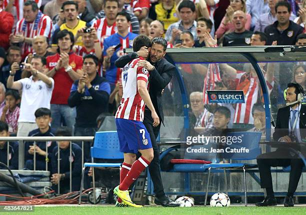 Adrian Lopez Alvarez of Atletico Madrid is congratulated by coach of Atletico Madrid Diego Simeone after being replaced during the UEFA Champions...