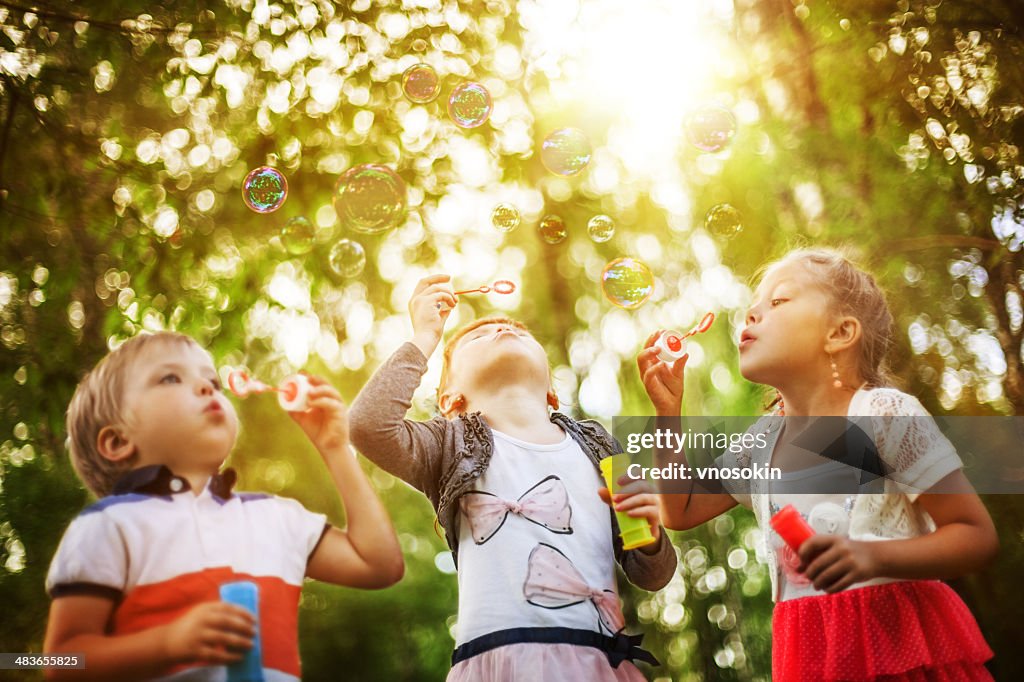 Children blowing bubbles