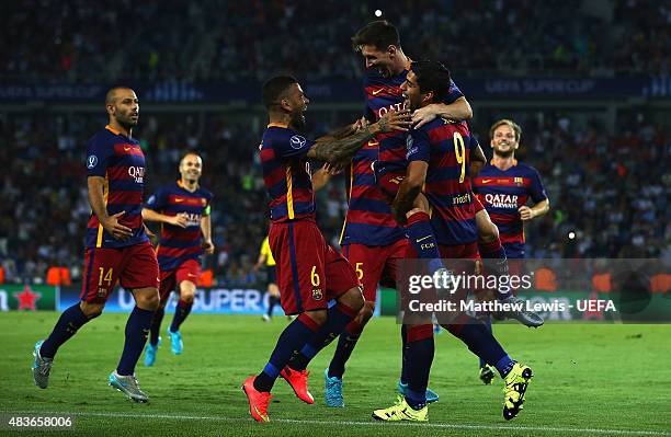 Lionel Messi of Barcelona is congratulated by Luis Suarez, after scoring his second goal by team mates during the UEFA Super Cup between Barcelona...