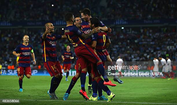 Lionel Messi of Barcelona is congratulated by Luis Suarez, after scoring his second goal by team mates during the UEFA Super Cup between Barcelona...