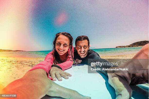 couple of surfers making a selfie - men selfie wide stock pictures, royalty-free photos & images