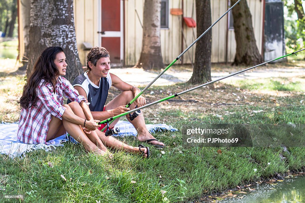 Young couple fishing at lake