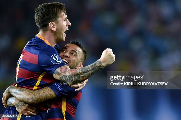 Barcelona's Brazilian defender Dani Alves and Barcelona's Argentinian forward Lionel Messi celebrate after scoring a goal during the UEFA Super Cup...