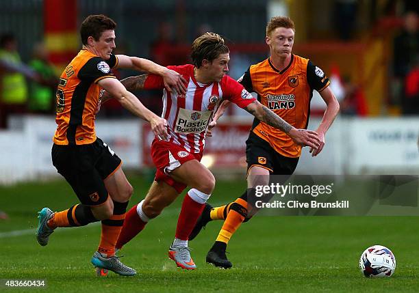 Josh Windass of Accrington Stanley in action with Andy Robertson and Sam Clucas of Hull City during the Capital One Cup First Round match between...