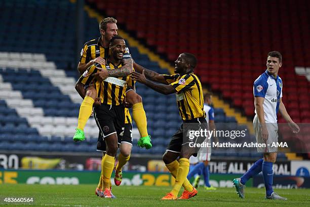 Tyrone Barnett of Shrewsbury Town celebrates after scoring a goal to make it 1-2 with Liam Lawrence and Abu Ogogo during the Capital One Cup First...